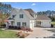 Side view of a charming two-story home with a three car garage at 127 Castle Dr, Mooresville, NC 28117