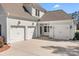 Side view of charming two-story home with a three car garage at 127 Castle Dr, Mooresville, NC 28117