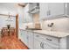 This kitchen boasts stainless steel appliances, granite counters, tile backsplash, and wood floors at 127 Castle Dr, Mooresville, NC 28117