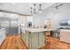 Bright kitchen features a spacious island with pendant lighting, stainless steel appliances, and hardwood floors at 127 Castle Dr, Mooresville, NC 28117