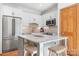 Bright kitchen featuring white cabinets, stainless steel appliances, and a granite countertop island at 127 Castle Dr, Mooresville, NC 28117