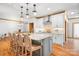 Beautiful kitchen island featuring pendant lights, granite countertops, and seating for four with hardwood floors at 127 Castle Dr, Mooresville, NC 28117