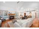 Open-concept living space featuring a stone fireplace, vaulted ceiling, wood floors, and seamless kitchen access at 127 Castle Dr, Mooresville, NC 28117