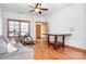 Living room with hardwood floors, natural light, ceiling fan, and a neutral-colored sofa at 127 Castle Dr, Mooresville, NC 28117