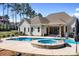 Backyard swimming pool, hot tub, covered patio, and a lush green yard ideal for entertaining at 127 Castle Dr, Mooresville, NC 28117