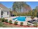 Stunning backyard pool with diving board, hot tub, mature trees, and space for lounging at 127 Castle Dr, Mooresville, NC 28117
