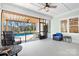 Covered porch with outdoor furniture, overlooking a pool and landscaped backyard at 127 Castle Dr, Mooresville, NC 28117
