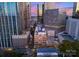A stunning aerial perspective highlighting the building's place in the city's urban landscape at dusk at 127 N Tryon St # 615, Charlotte, NC 28202