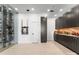 Entertainment room featuring a large wine rack, pool cues, and a wet bar at 127 N Tryon St # 615, Charlotte, NC 28202