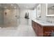 Modern bathroom featuring a glass shower, double vanity, and neutral tile flooring at 127 N Tryon St # 615, Charlotte, NC 28202