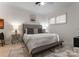 Comfortable bedroom featuring a tufted headboard, natural light, and a soft rug at 127 N Tryon St # 615, Charlotte, NC 28202