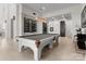 Spacious game room featuring a pool table, wine storage, and elegant lighting at 127 N Tryon St # 615, Charlotte, NC 28202