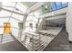 Bright hallway features natural light, skylights, and a modern railing at 127 N Tryon St # 615, Charlotte, NC 28202