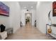 Inviting hallway with light hardwood floors, neutral walls, and elegant decor leading to various rooms at 127 N Tryon St # 615, Charlotte, NC 28202