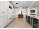 Well-lit kitchen with white cabinets, light wood floors, and a red range cooker at 127 N Tryon St # 615, Charlotte, NC 28202