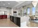 Open concept kitchen with island, bar seating, modern appliances and large windows at 127 N Tryon St # 615, Charlotte, NC 28202