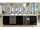 Kitchen island with bar seating, built-in dishwasher, and wine refrigerator at 127 N Tryon St # 615, Charlotte, NC 28202