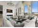 Spacious living room with large windows, stylish seating, modern fireplace, and a unique accent wall at 127 N Tryon St # 615, Charlotte, NC 28202