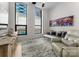 Bright living room with floor-to-ceiling windows, hardwood floors, and elegant furnishings, filled with natural light at 127 N Tryon St # 615, Charlotte, NC 28202