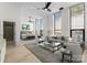 Open living room and bedroom area with modern furnishings and lots of natural light at 127 N Tryon St # 615, Charlotte, NC 28202