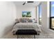 Cozy main bedroom with a queen bed, modern decor, and lots of natural light at 127 N Tryon St # 615, Charlotte, NC 28202