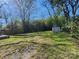 Picturesque backyard showcasing a lush lawn, mature trees, and shed at 146 Saluda St, Chester, SC 29706
