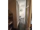 Narrow bathroom featuring a stand-up shower, commode, wall decor, and black tile floors at 146 Saluda St, Chester, SC 29706