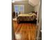 Bedroom features hardwood floors, soft natural light and a floral comforter on the cozy wood-framed bed at 146 Saluda St, Chester, SC 29706