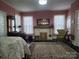 Bright and airy bedroom featuring a cozy fireplace, classic furniture, and a decorative area rug at 146 Saluda St, Chester, SC 29706