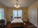 Inviting bedroom featuring a queen-size bed, hardwood floors, and ample natural light from multiple windows at 146 Saluda St, Chester, SC 29706