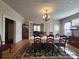 Spacious dining room with a chandelier, table set for dinner, and hardwood floors at 146 Saluda St, Chester, SC 29706