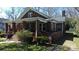 Inviting brick home with a cozy porch and lush greenery at 146 Saluda St, Chester, SC 29706