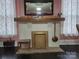 Close-up of the living room fireplace showing brickwork, mantle, and decorative details at 146 Saluda St, Chester, SC 29706