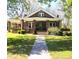 Charming brick home with a covered front porch and well-maintained lawn at 146 Saluda St, Chester, SC 29706