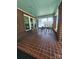 Inviting front porch with a swing, brick columns, and tiled flooring at 146 Saluda St, Chester, SC 29706