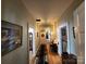 Long hallway with beautiful hardwood floors, arched doorways, and unique wall decor at 146 Saluda St, Chester, SC 29706
