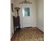 Entryway featuring decorative glass door, vintage furnishings, and patterned rug on wood flooring at 146 Saluda St, Chester, SC 29706