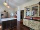 Bright kitchen showcasing stainless steel fridge, kitchen island, and a charming china cabinet at 146 Saluda St, Chester, SC 29706