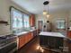 Well-lit kitchen featuring stainless appliances, gas range, custom cabinetry, and a center island with white countertop at 146 Saluda St, Chester, SC 29706