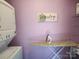 Functional laundry room with a washer/dryer, laundry sign and ironing board at 146 Saluda St, Chester, SC 29706