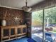 Charming living room with brick accent wall, a hutch, and sliding glass door to the backyard at 146 Saluda St, Chester, SC 29706