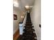Charming staircase with a floral carpet runner and wooden banister at 146 Saluda St, Chester, SC 29706
