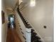 Elegant staircase with a patterned carpet runner and hardwood flooring at 146 Saluda St, Chester, SC 29706