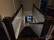 Staircase featuring a carpet runner, wooden banister, and view into other rooms at 146 Saluda St, Chester, SC 29706