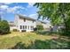 Scenic backyard featuring a patio, grill, shed, and lush greenery perfect for relaxation and entertaining at 15619 Lakepoint Forest Dr, Charlotte, NC 28278
