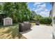 Backyard showcasing the lawn, patio area with a grill, and a storage shed perfect for outdoor activities at 15619 Lakepoint Forest Dr, Charlotte, NC 28278