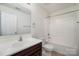 Bathroom features a vanity with a white sink, mirror, and a shower-tub combo at 15619 Lakepoint Forest Dr, Charlotte, NC 28278