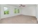 Spacious bedroom with ceiling fan and multiple windows offering bright, natural light and a pleasant atmosphere at 15619 Lakepoint Forest Dr, Charlotte, NC 28278