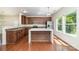 Modern kitchen features dark wood cabinets, granite countertops, stainless steel appliances, and a large kitchen island at 15619 Lakepoint Forest Dr, Charlotte, NC 28278