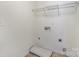 A simple laundry room with a shelf, tile floor and hookups at 15619 Lakepoint Forest Dr, Charlotte, NC 28278